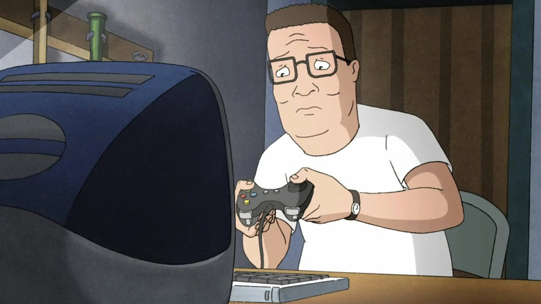 Hank Hill is struggling to use a computer control device and games in King of the Hill