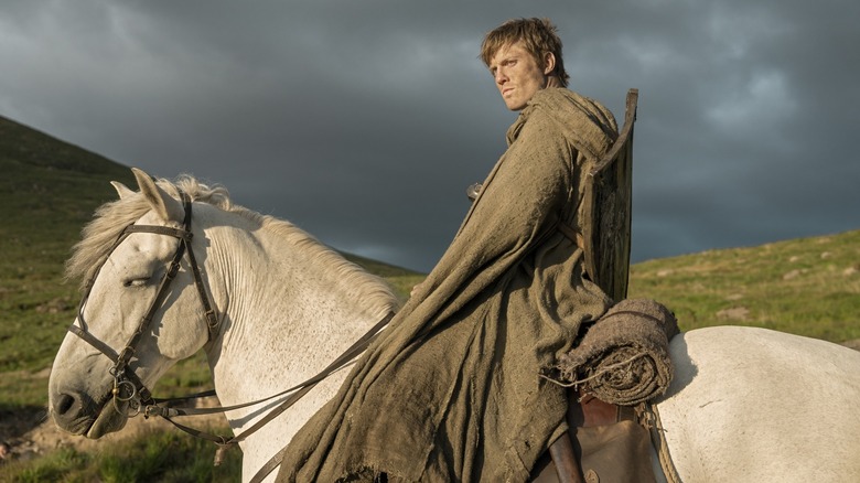 Peter Claffey as Ser Duncan the Tall riding atop a horse in the countryside in A Knight of the Seven Kingdoms