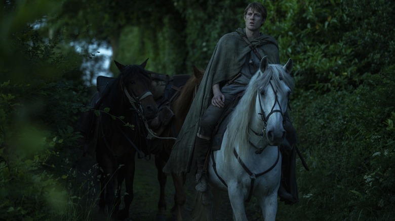 Peter Claffey as Ser Duncan the Tall riding a horse through a wooded path in A Knight of the Seven Kingdoms