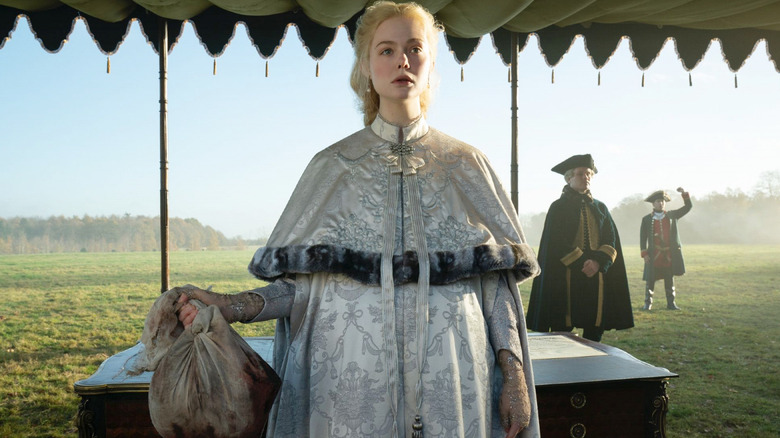 Elle Fanning with a severed head in The Great
