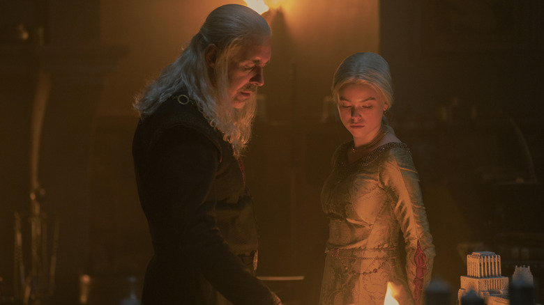Viserys looking at a flame with Rhaenyra by his side in his chambers on Game of Thrones