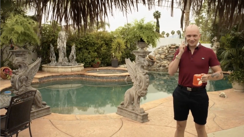NoHo Hank standing by a pool 
