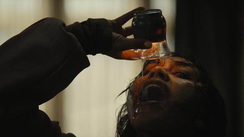 Someone drinks candle wax in Evil Dead Burn