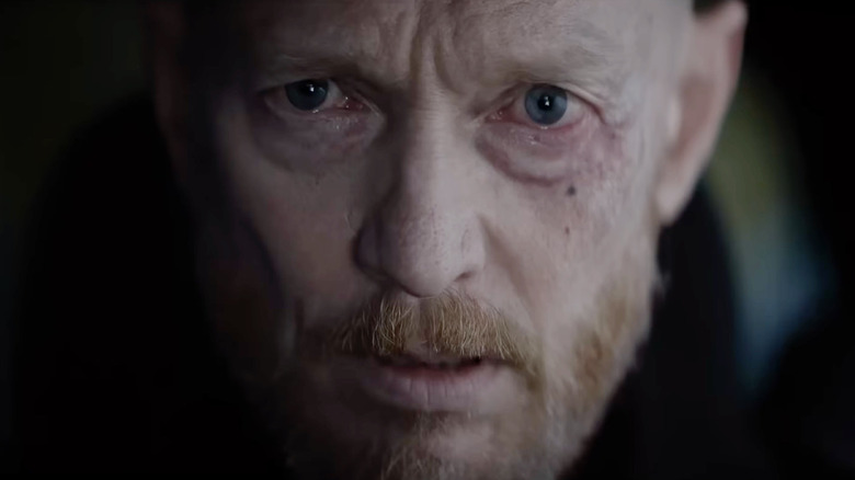 A man with a beard looking terrified in Evil Dead Burn