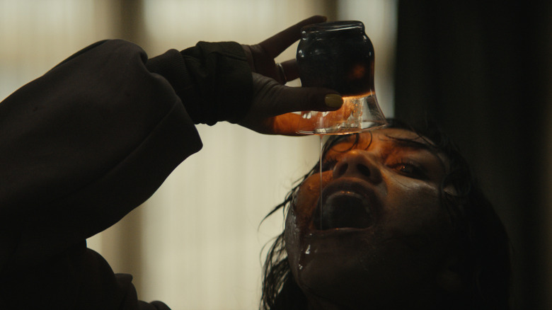 A possessed Thya drinks wax in Evil Dead Burn