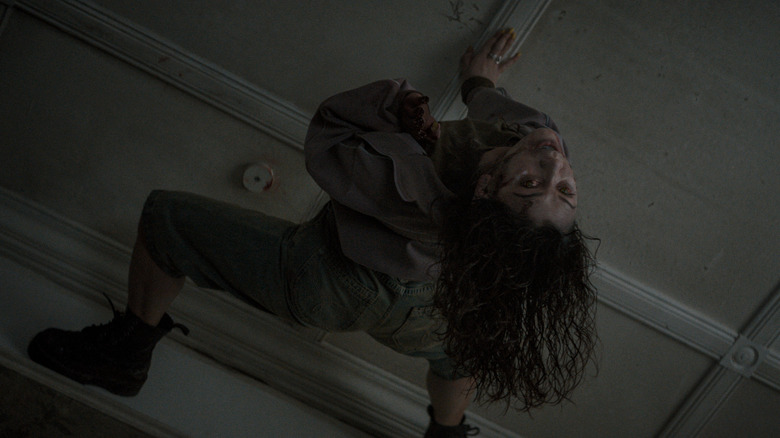A possessed Thya crawls on the ceiling in Evil Dead Burn