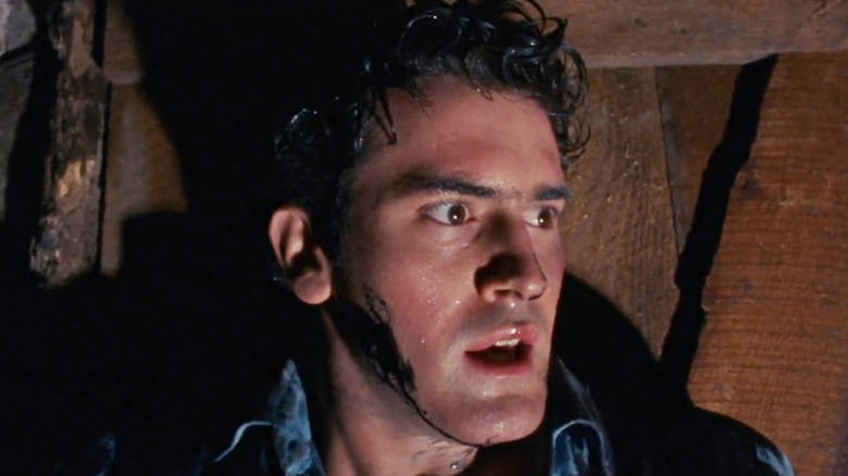 Bruce Campbell looking terrified in The Evil Dead