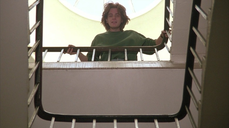 Alex looking down from a landing in Shallow Grave