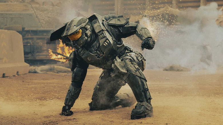 The Master Chief strikes his signature pose, one arm planted into the ground, the other ready to fight, in Halo