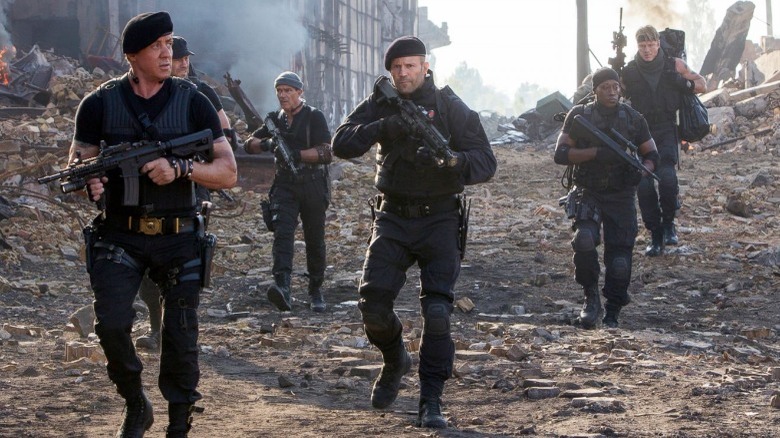 Soldiers walk through rubble