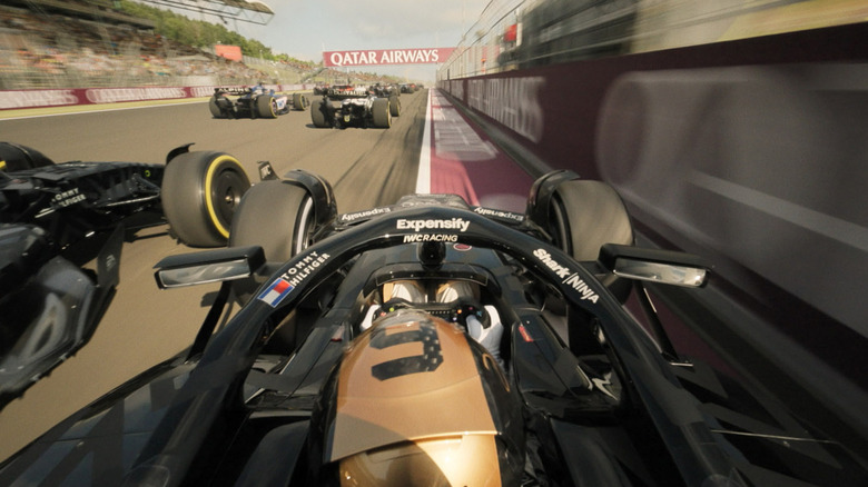 An APXGP car racing against other cars near the wall in F1