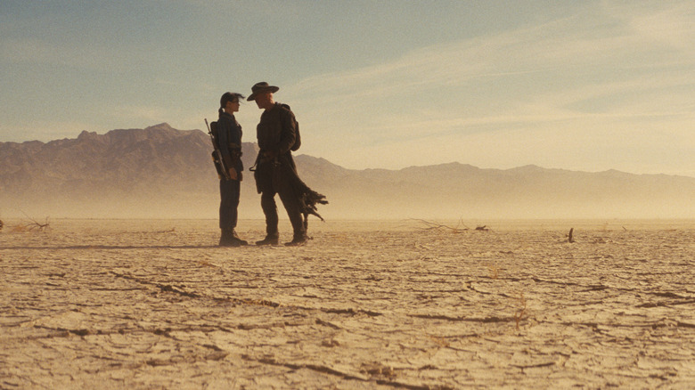 Walton Goggins as The Ghoul confronting Ella Purnell as Lucy MacLean up close in the middle of a desert in Fallout