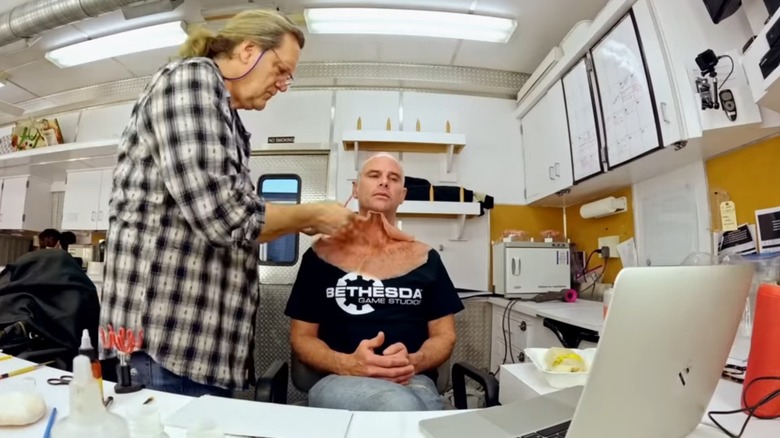 Jake Garber putting prosthetics on Walton Goggins as The Ghoul