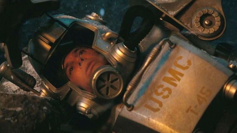 Cooper Howard trapped in a faulty power armor about to be killed by a deathclaw in Fallout