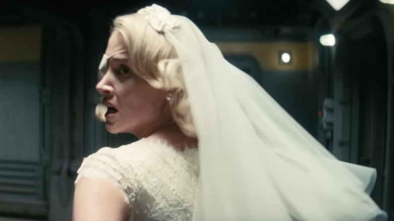 Annabel O'Hagan as Stephanie Harper wearing a wedding dress and running through a hallway in Fallout season 2