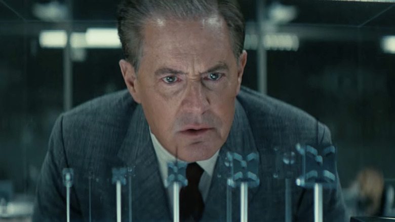 Kyle MacLachlan as Hank inspects several mind-control chips in Fallout