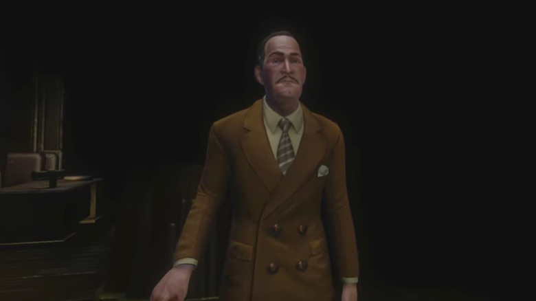 ஆர்மின் ஷிமர்மேனின் ஆண்ட்ரூ ரியான் பயோஷாக்கில் பழுப்பு நிற உடையில் நம்பிக்கையுடன் இருக்கிறார்