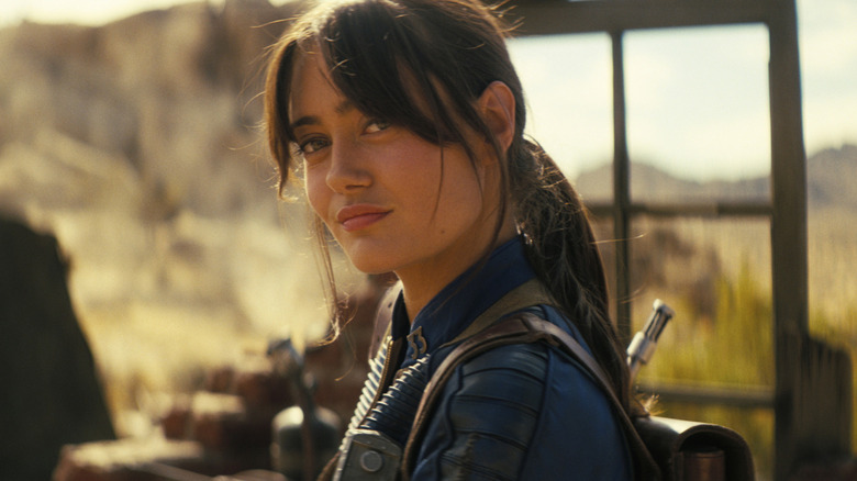 Lucy MacLean smiling against a desert backdrop in Fallout