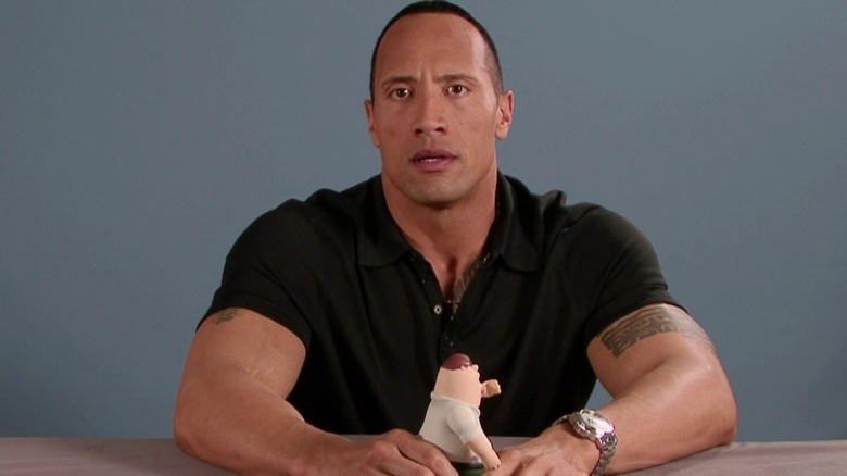 Dwayne Johnson holding a Peter doll on Family Guy