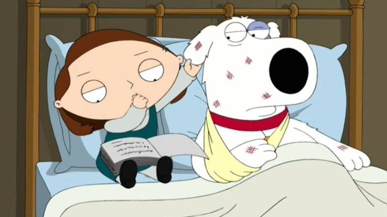 Stewie holding Brian's ear while reading a book on Family Guy