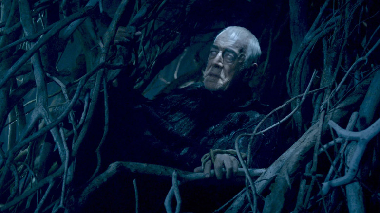 The Three-Eyed Raven trying to talk to the youth while being stuck to a tree in Game of Thrones