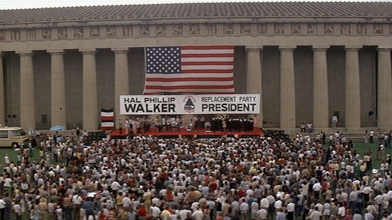 Hal Phillip Walker banner and American flag in front of crowd in Nashville