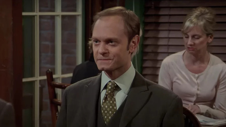 Frasier's Niles sitting in suit and tie