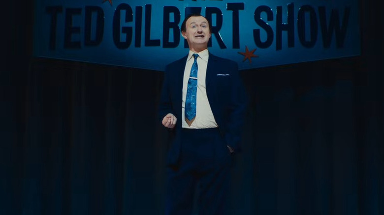 Mark Gatiss as Ted Gilbert hosting his talk show in The Fantasic Four: First Steps
