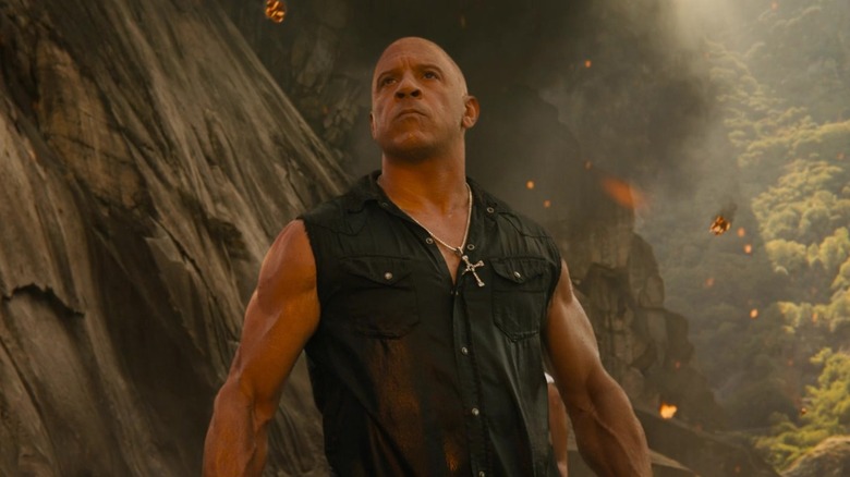 Dom Toretto in a ravine, looking up at something scary in Fast X