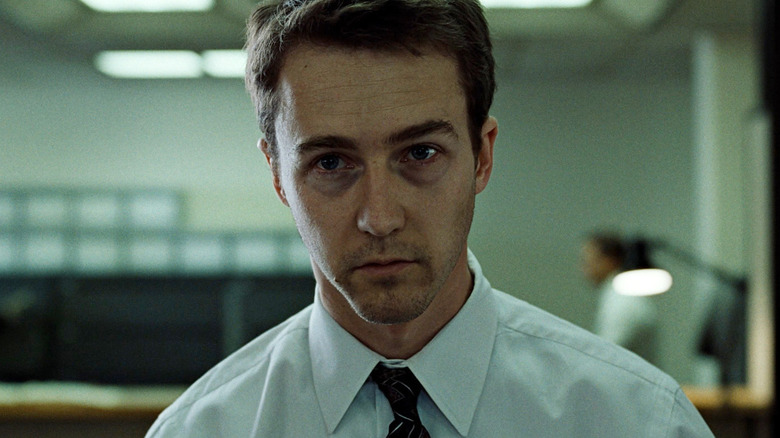 Edward Norton as Jack/The Narrator in Fight Club, looking dazed in his office