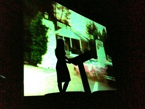 A silhouette of screenwriter Jenny Lumet, with a Jonathan Demme montage playing in the background
