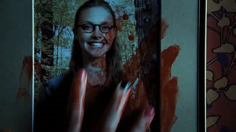 Jennifer's hand on Needy's photo in Jennifer's Body
