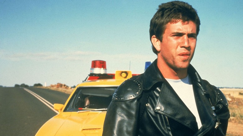 Mel Gibson in front of police car Mad Max