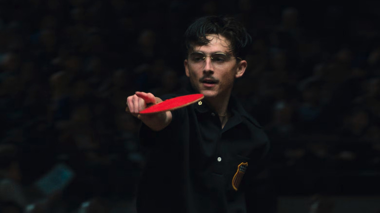 Timothée Chalamet as Marty Mauser playing in a table tennis tournament in Marty Supreme