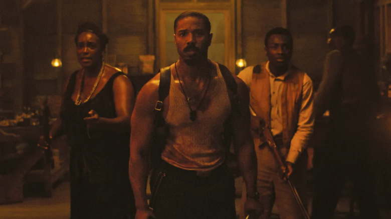 Michael B. Jordan, Wunmi Mosaku, and Miles Caton as Smoke, Annie, and Sammie ready to fight vampires in the bar in Sinners