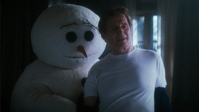 Frank Drebin Jr. (Liam Neeson) being undressed by a snowman in The Naked Gun (2025)