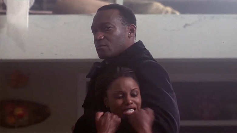 A young black woman being held by Candyman.