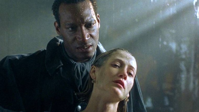 Candyman stands behind a woman