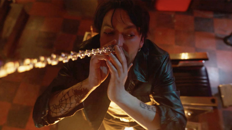 Erik with his septum ring stuck to a chain in Final Destination Bloodlines