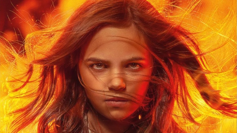 Charlie with fire behind her in a poster for "Firestarter" (2022)