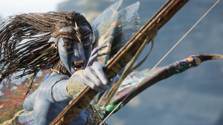 Neytiri firing an arrow with fury in Avatar: Fire and Ash
