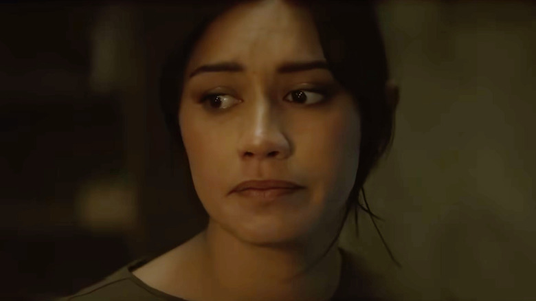 A young woman looking worried in Evil Dead Burn