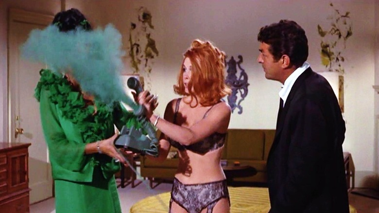 Matt Helm and Gail watching a woman getting gassed from a trick telephone in The Silencers