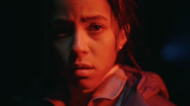 Lou Llobell as a woman screaming with fire surrounding her in Passenger