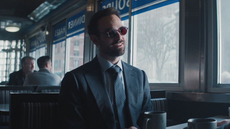 Matt Murdock smiling at a restaurant cabin in Daredevil: Born Again