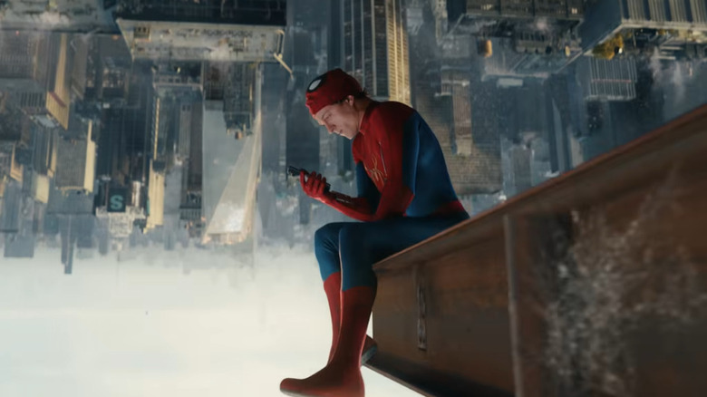 Peter Parker sits upside-down looking at his phone in Spider-Man: Brand New Day
