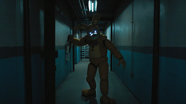 William Afton inside of the Springtrap animatronic holding a knife in a hallway in Five Nights at Freddy's 2