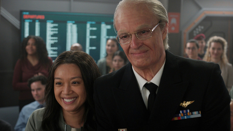 Ed and Kelly Baldwin smiling during a ceremony on Mars in For All Mankind