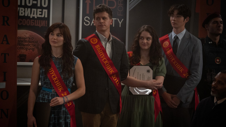 Lily, Marcus, Gulsora, and Alex standing together during their graduation ceremony on Mars in For All Mankind