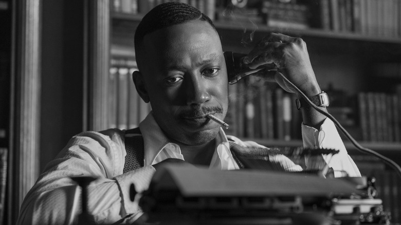 Robbie on the phone looking down at his typewriter in Spider-Noir